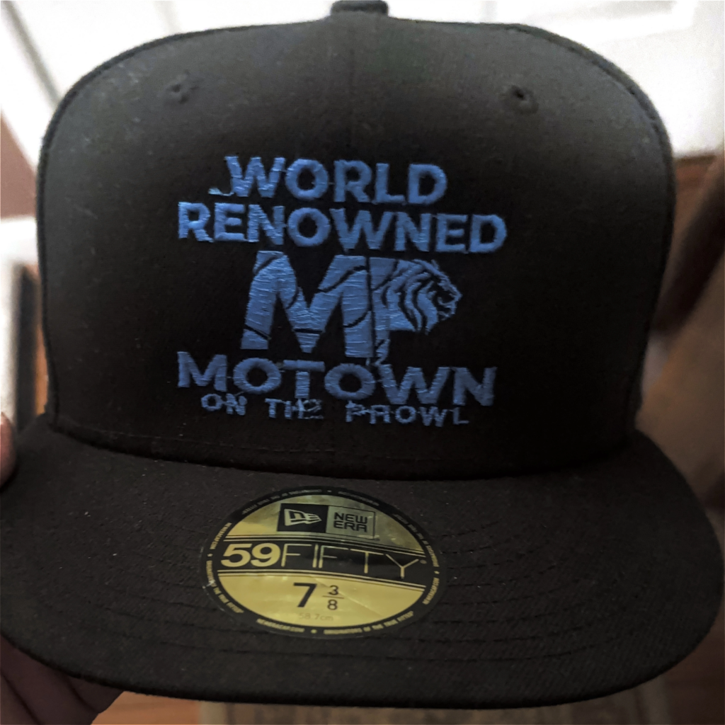 Black Motown cap with blue text and logo.
