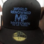 Black Motown cap with blue text and logo.